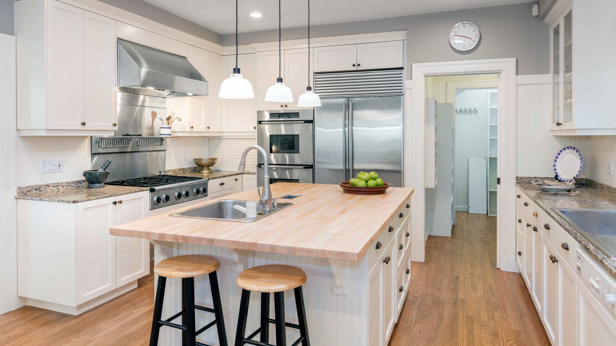 Luxury Kitchen Interior in white with wooden floor and kitchen island