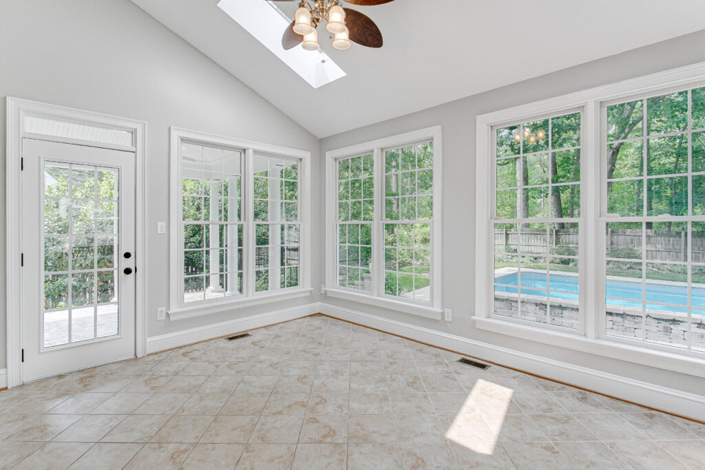 New sunroom without furniture and with pool outside