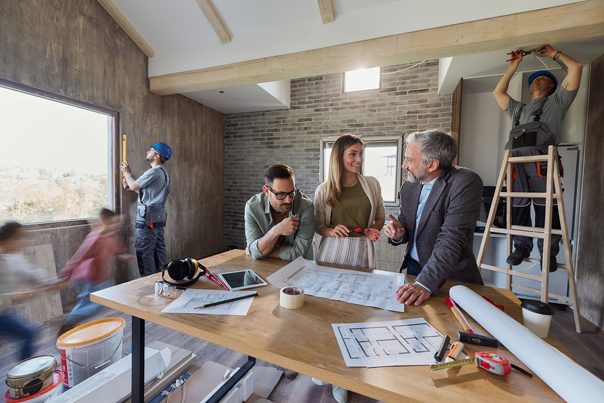 client with worker looking at blueprints client with worker looking at blueprints